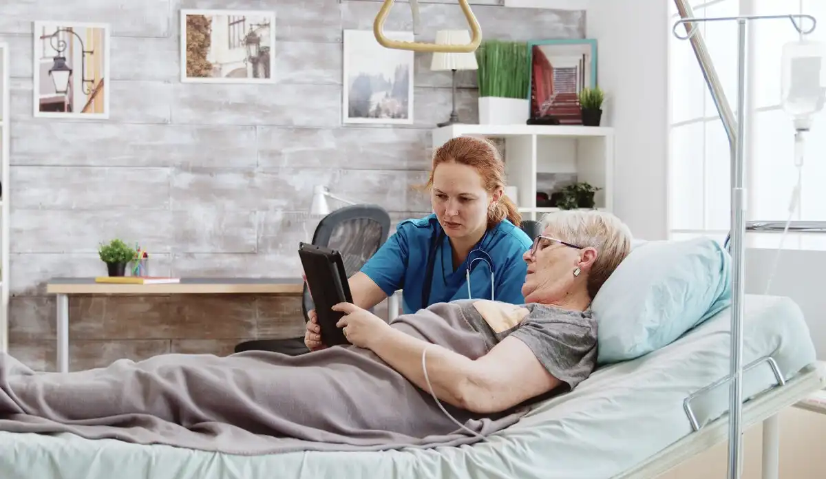 Compassionate doctor holding an elderly patient's hand, symbolizing the difference between palliative care and hospice care in a warm, home-like medical setting.